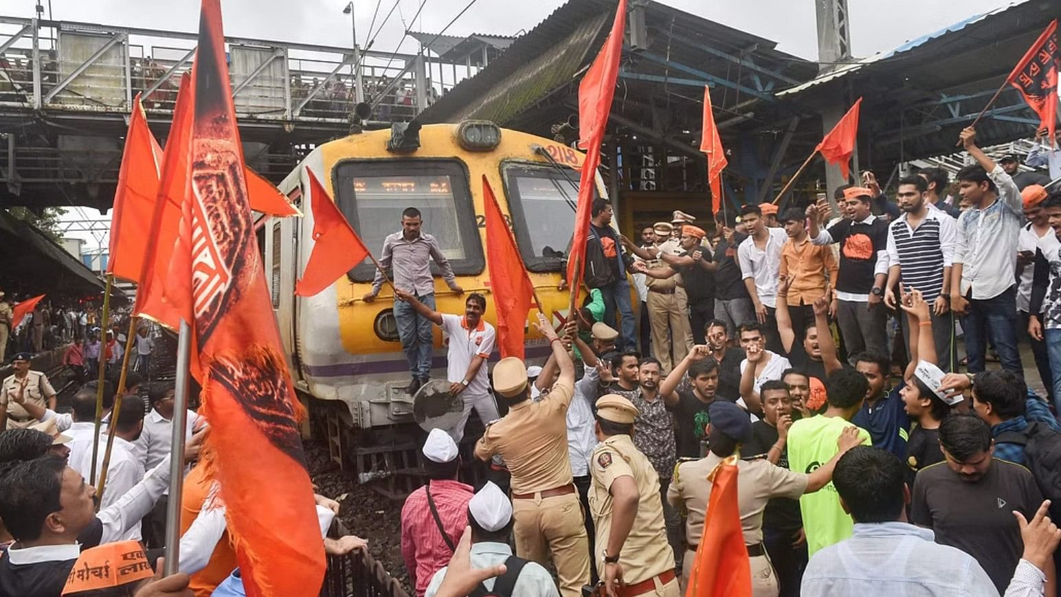 <div class="paragraphs"><p>Maratha Kranti Morcha protesters stop a train during their statewide bandh called for reservations in jobs and education in Thane on Wednesday July 25 2018.</p></div>
