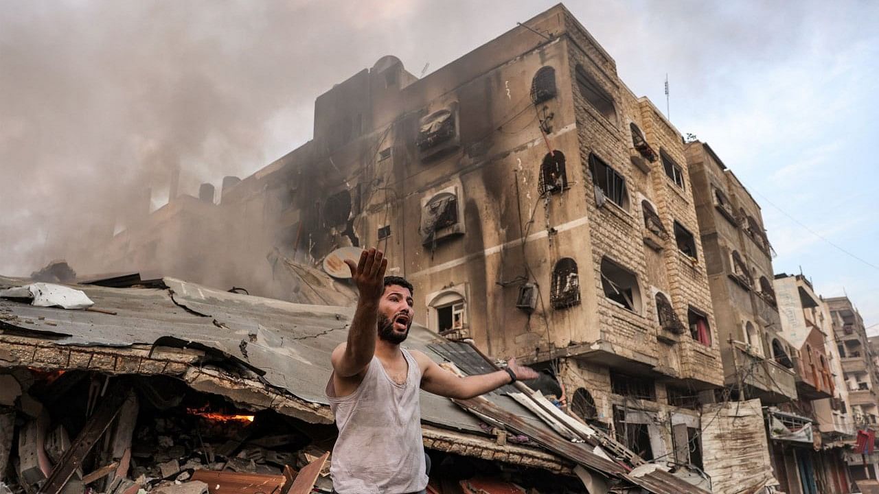 <div class="paragraphs"><p>A Palestinian looking at the devastation from Israeli air strikes</p></div>