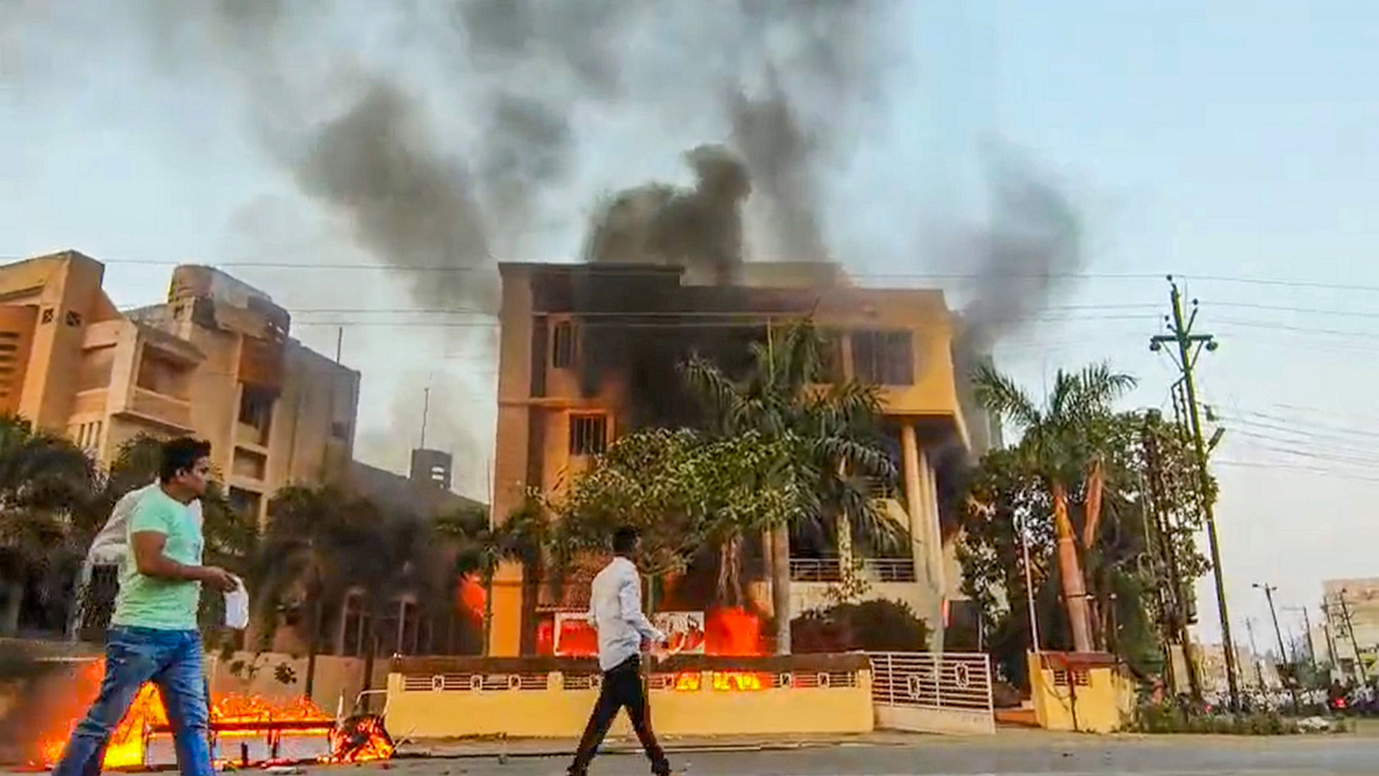 <div class="paragraphs"><p> Smoke billows after an office of NCP was set on fire by Maratha reservation agitators, in Beed district, Maharashtra, Monday, 30 October, 2023.</p></div>