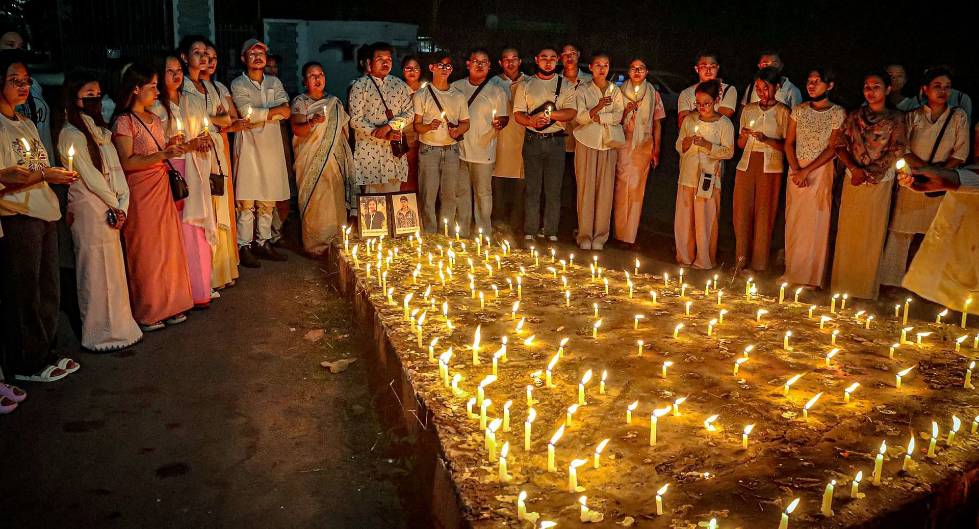 <div class="paragraphs"><p>People take part in a candlelight vigil in Imphal against the "killing" of two missing students by unknown miscreants and demand peace in Manipur.</p></div>