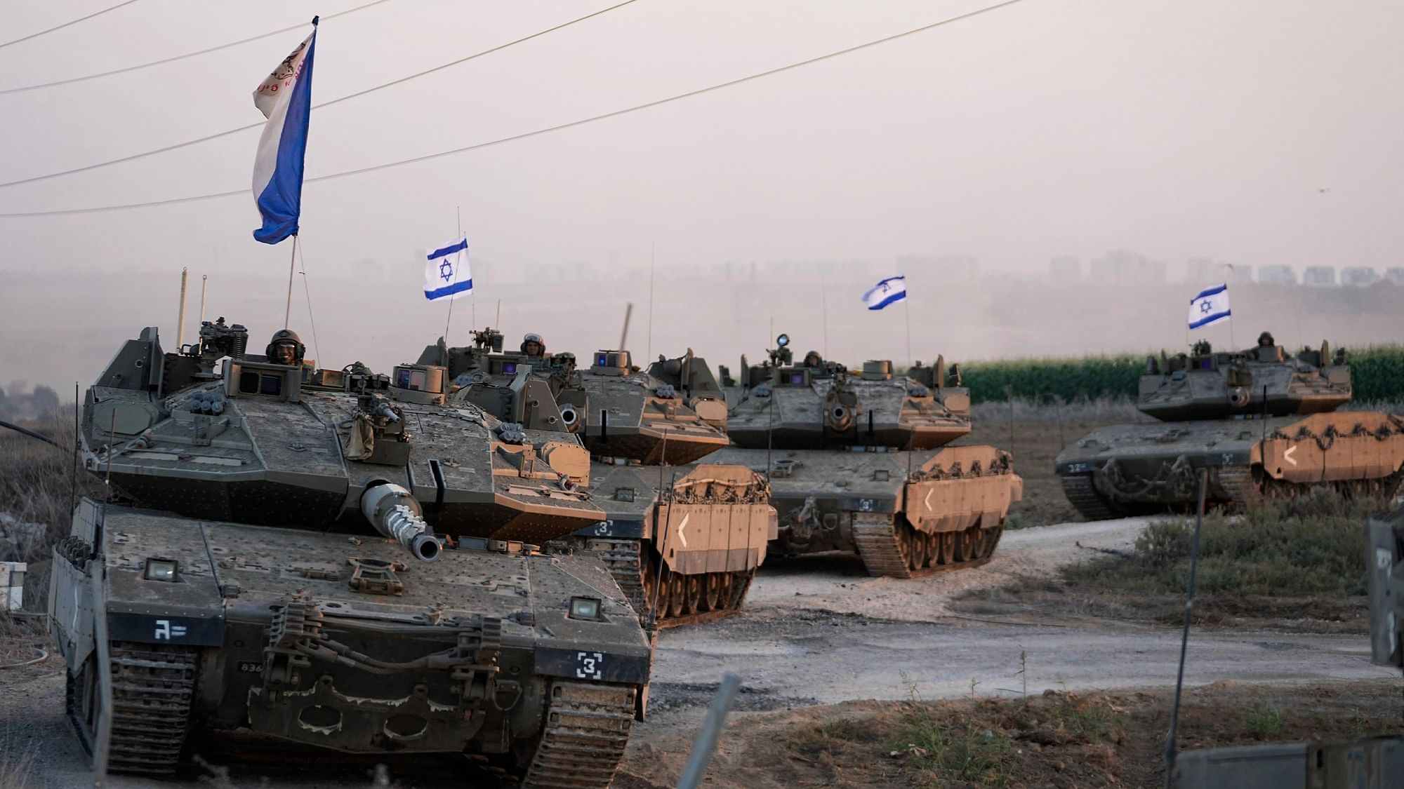 <div class="paragraphs"><p>Israeli tanks head towards the Gaza border in southern Israel on Thursday, 12 October. </p></div>