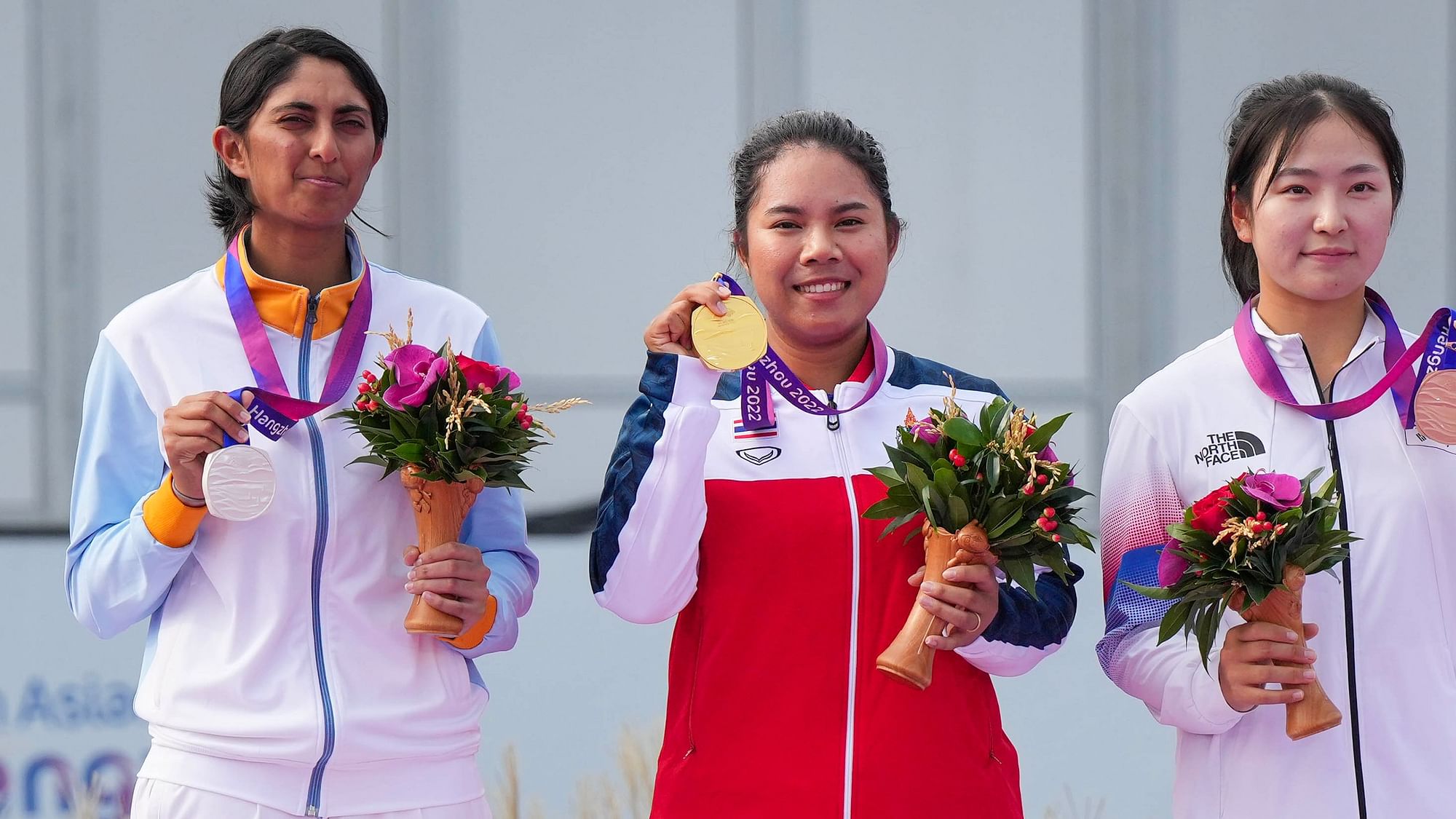 <div class="paragraphs"><p>Hangzhou: India's silver medalist Aditi Ashok stands on the podium with Thailand's gold medalist Arpichaya Yubol and Republic of Korea’s bronze medalist Hyunjo Yoo during the presentation ceremony of the Women’s Individual Golf Round 4 event at the 19th Asian Games, in Hangzhou, China, Sunday, Oct. 1, 2023. </p></div>