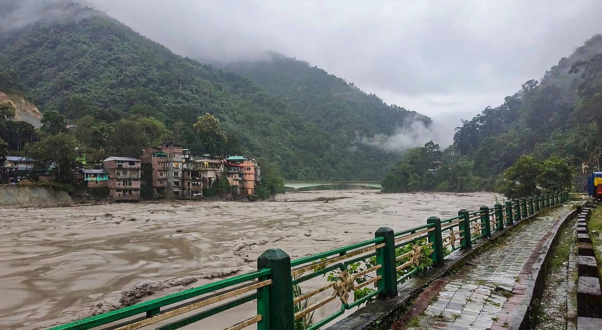 <div class="paragraphs"><p>Flooded Teesta river in north Sikkim on Wednesday, 4 October. A sudden cloud burst over Lhonak Lake in North Sikkim has resulted in a flash flood in the Teesta River in Lachen valley, which was compounded by the release of water from a dam, leading to 23 army personnel being washed away, camps and vehicles being submerged.</p></div>
