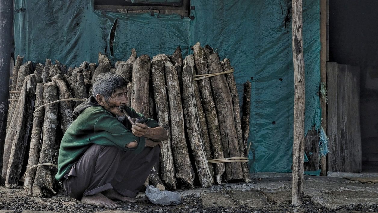 <div class="paragraphs"><p>Khasi tribal man  smoking a handmade pipe in front of his home at Cherrapunji [Meghalaya, India].</p></div>
