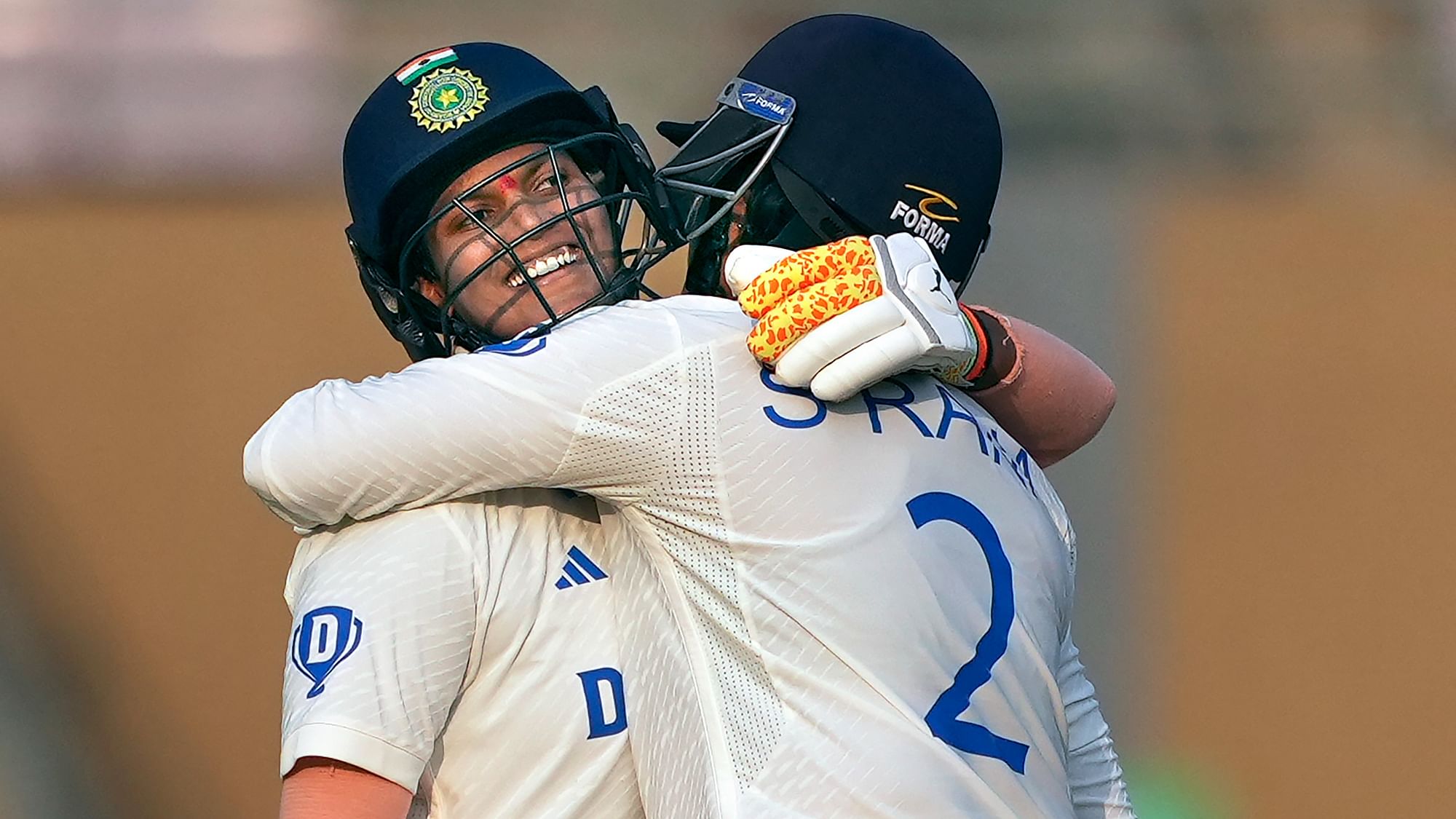 <div class="paragraphs"><p>Deepti Sharma with teammate Sneh Rana celebrates her fifty during the first day of the one-off test cricket match between India Women and England Women, at DY Patil Stadium, in Navi Mumbai, Thursday, Dec. 14, 2023.</p></div>