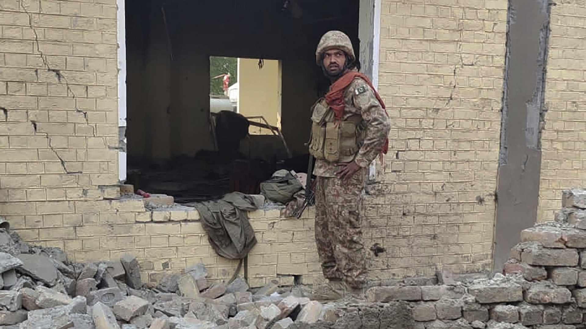 <div class="paragraphs"><p>An army soldier examines damages on the site of a bombing at a police station on the outskirts of Dera Ismail Khan.</p></div>