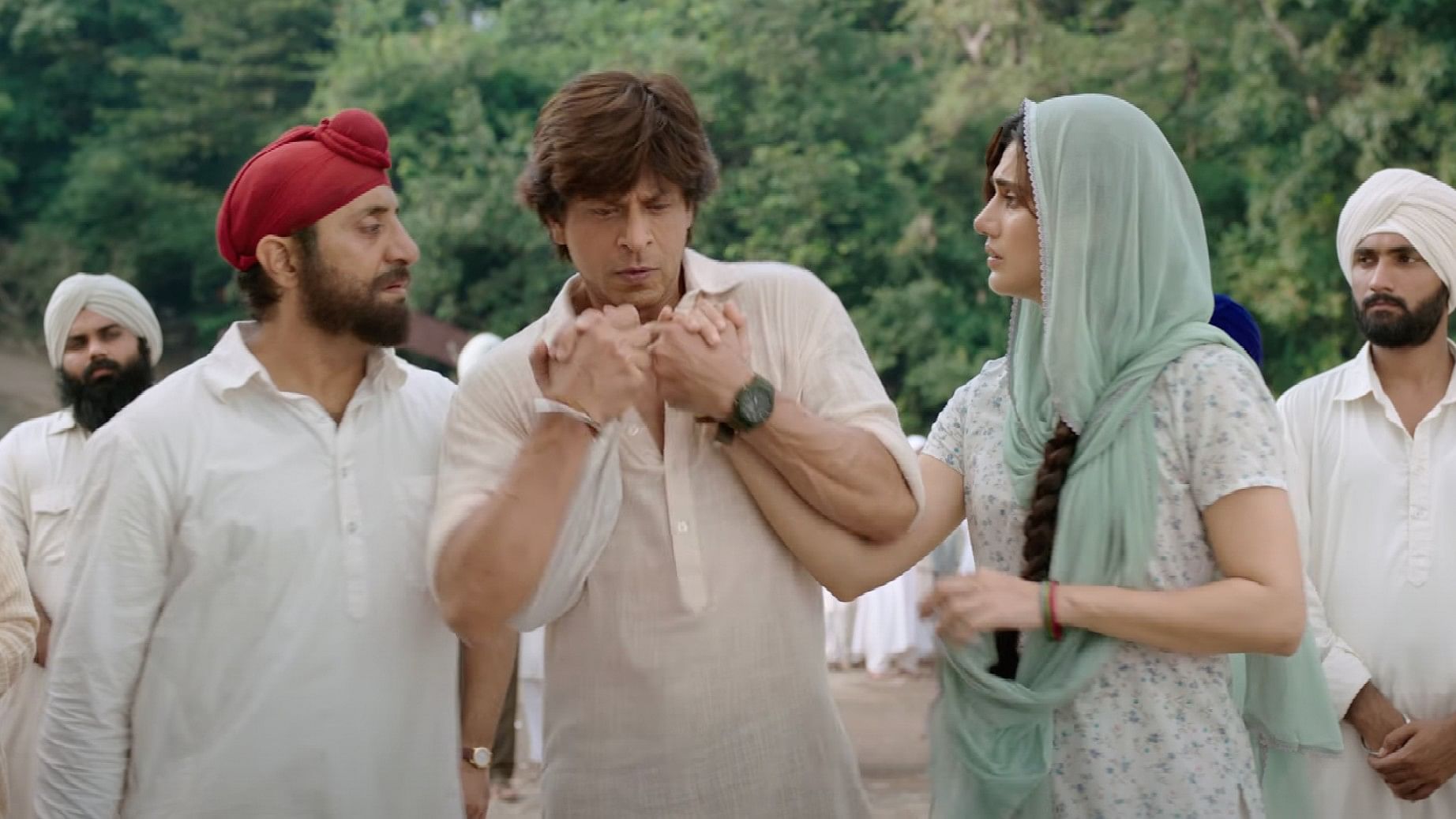 <div class="paragraphs"><p>Shah Rukh Khan, Taapsee Pannu and Anil Grover in a still from <em>Dunki</em>.</p></div>