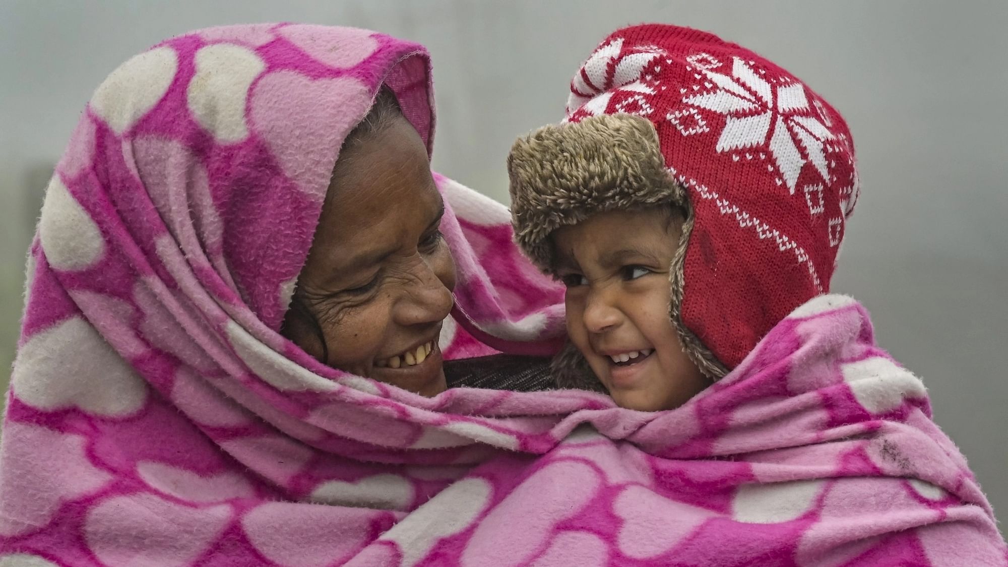 <div class="paragraphs"><p>A woman with her child during a cold winter morning, in Nadia, on Tuesday, 9 January.</p></div>