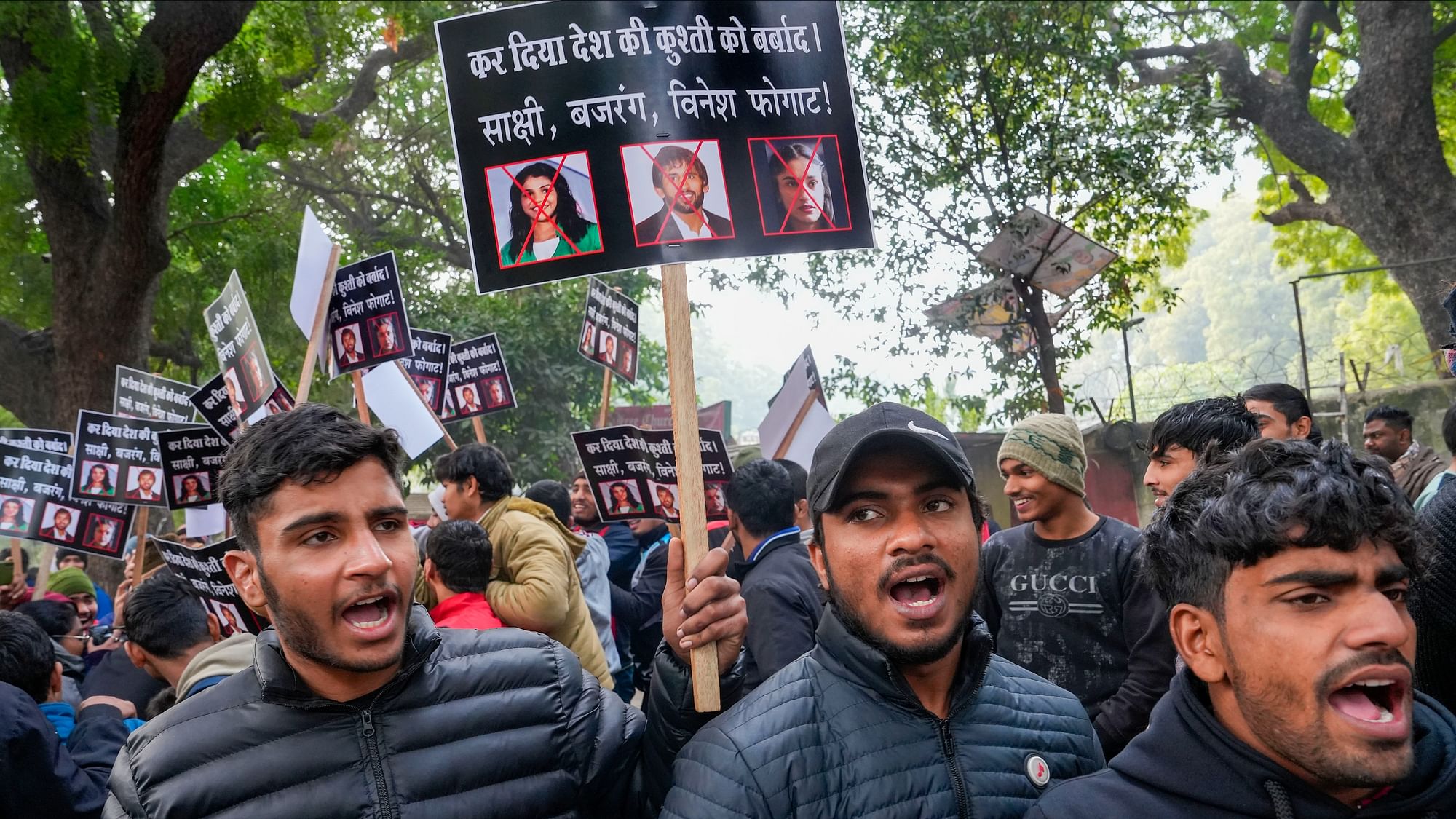 <div class="paragraphs"><p>Wrestlers hold placards during a protest against wrestlers Sakshi Malik, Bajrang Punia and Vinesh Phogat at Jantar Mantar, in New Delhi, Wednesday, Jan. 3, 2024. The ongoing crisis in Indian wrestling took a fresh twist on Wednesday when hundreds of junior wrestlers assembled at Jantar Mantar to protest against the loss of one crucial year of their careers, a situation for which they blamed top grapplers Bajrang Punia, Sakshi Malik and Vinesh Phogat.</p></div>