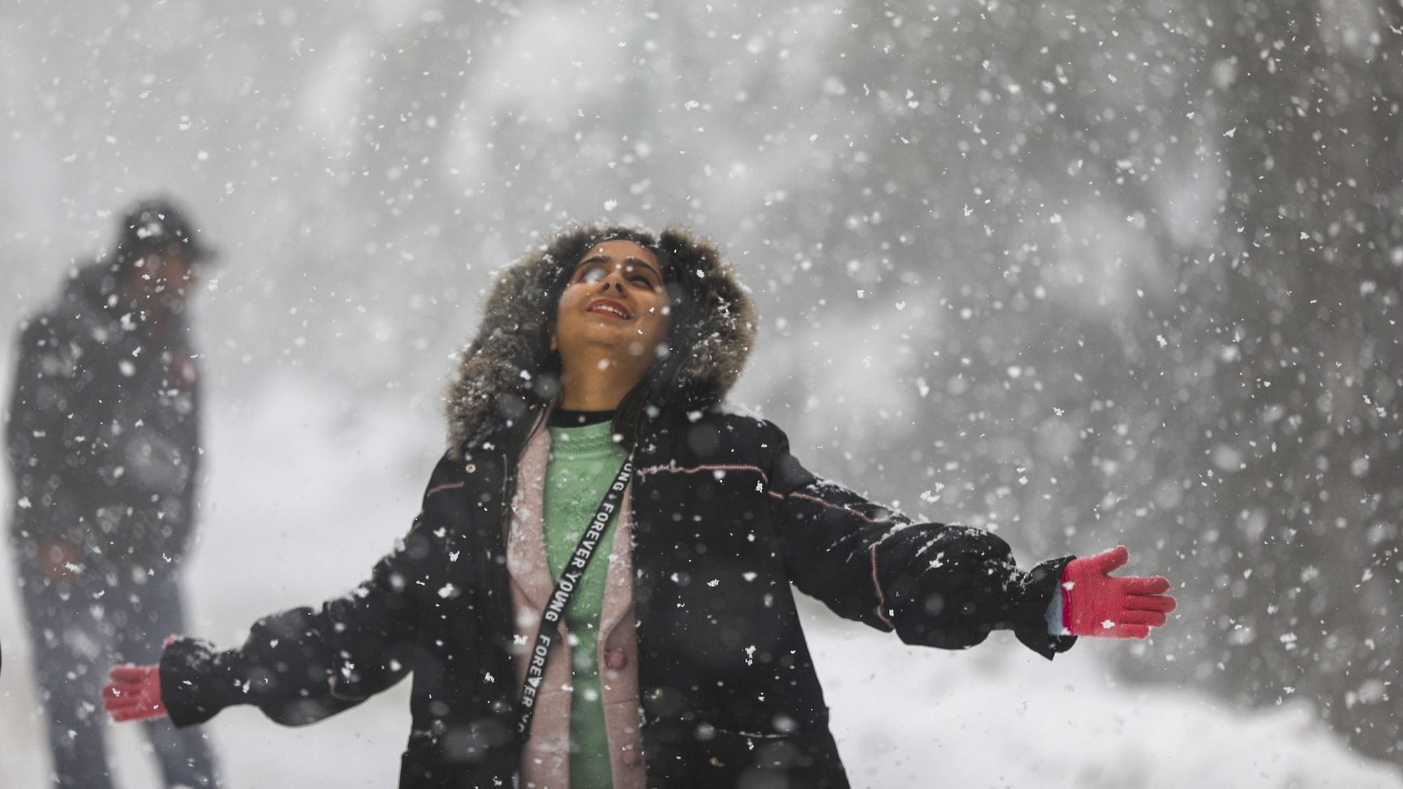 <div class="paragraphs"><p>A tourist during snowfall at Patnitop hill station, in Jammu &amp; Kashmir, on Sunday, 4 February.</p></div>