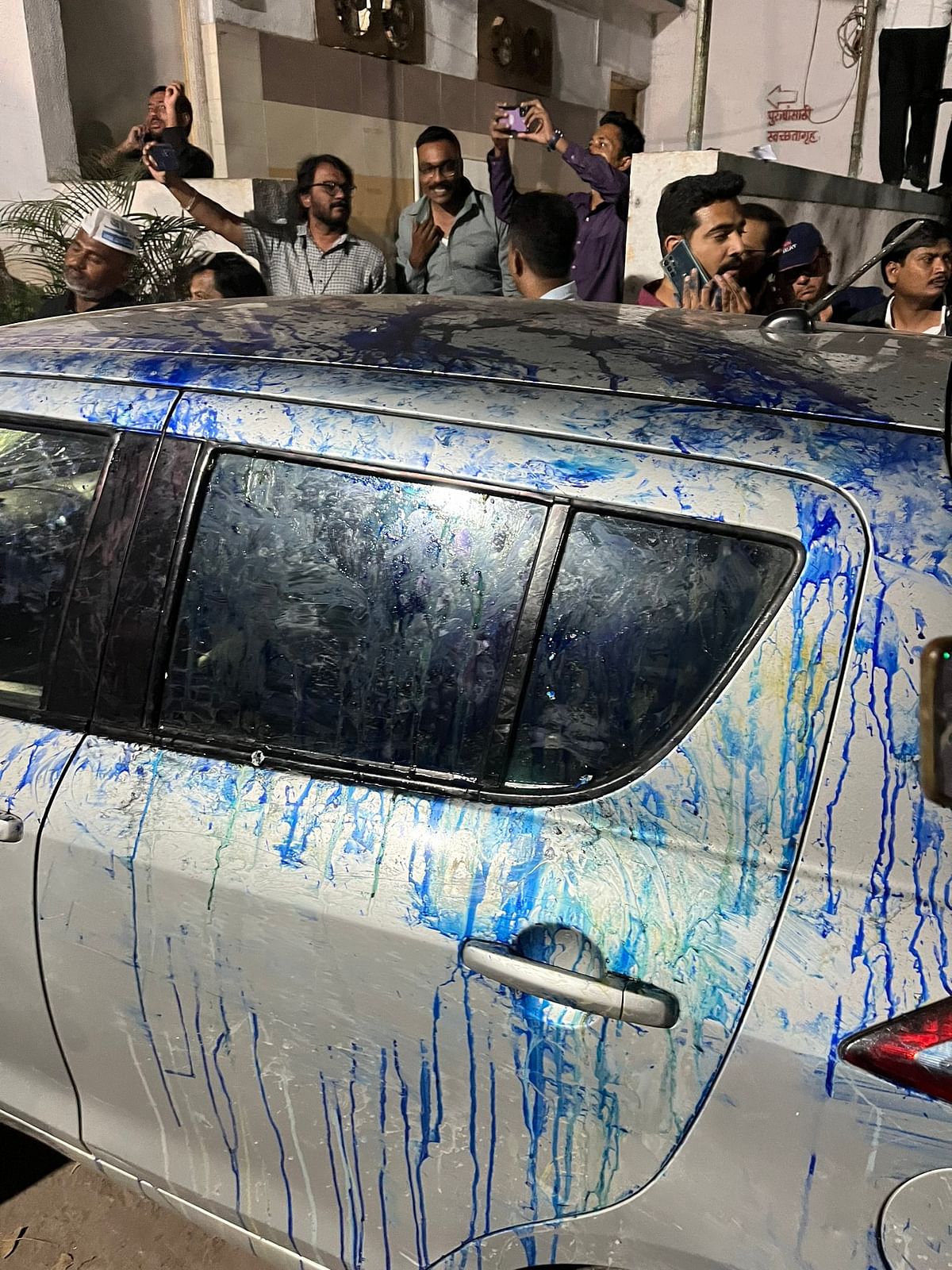 Visuals show ink being thrown, and stones and eggs being pelted on the car with Wagle and two others were in it.
