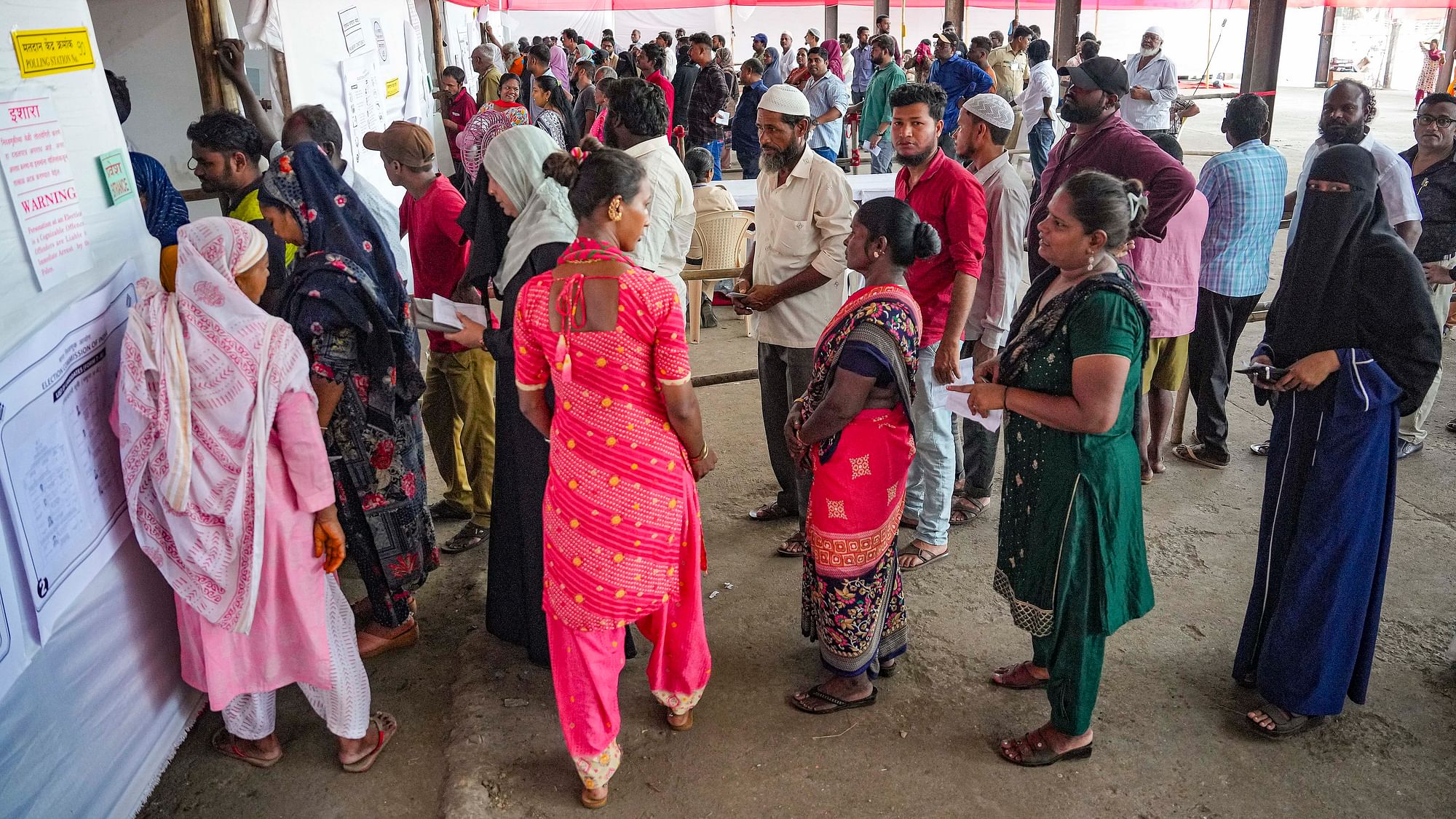 <div class="paragraphs"><p>Voters wait in a queue at a polling station to cast their votes for the fifth phase of Lok Sabha elections, in Mumbai, Monday, 20 May, 2024.</p></div>