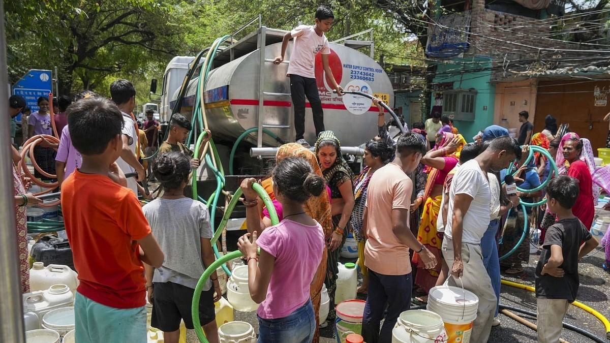 <div class="paragraphs"><p>Residents fill water from a tanker amid a water crisis at Chanakyapuri's Vivekanand Camp.</p></div>