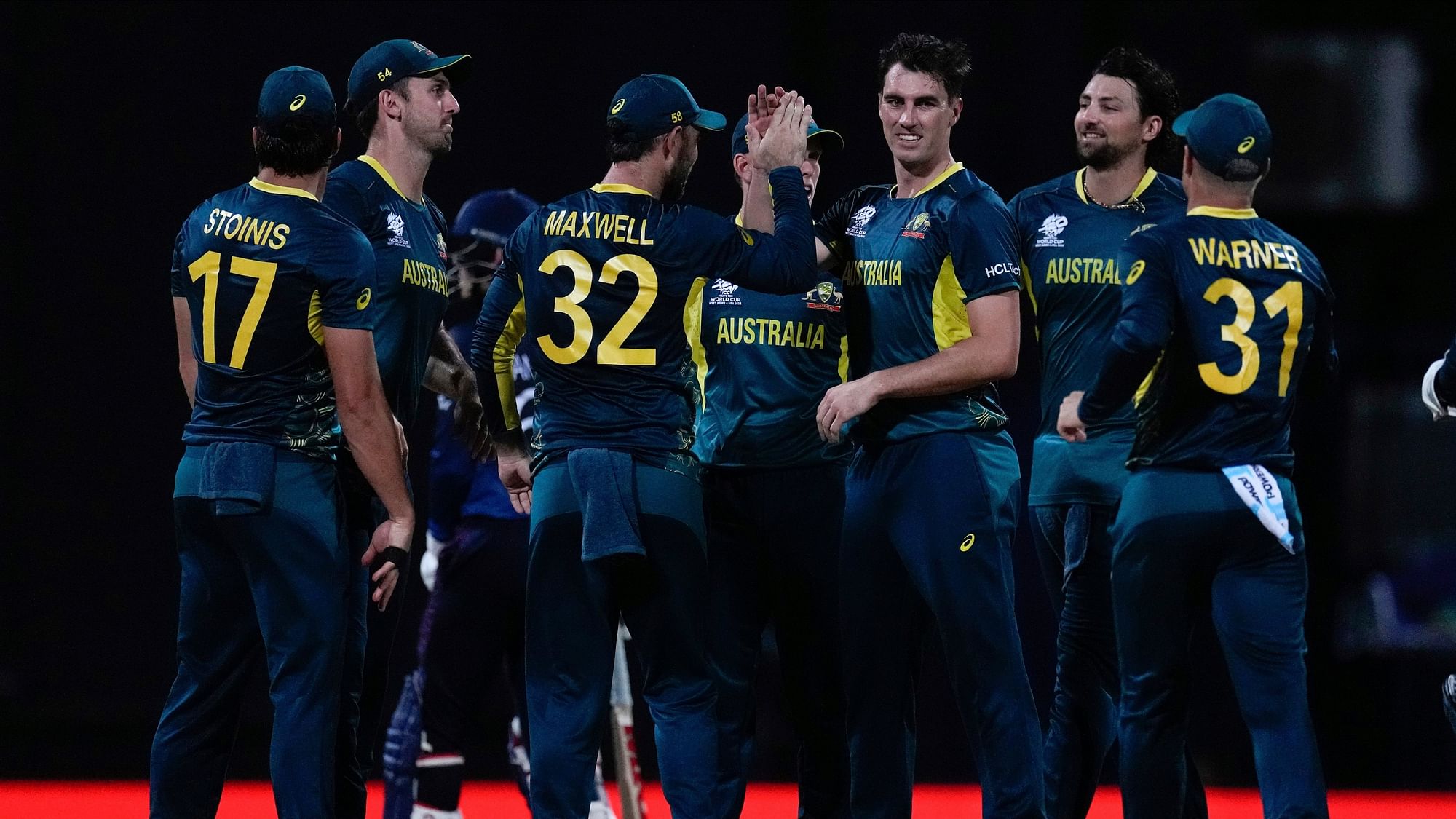 <div class="paragraphs"><p>Australia's Pat Cummins, third from right, celebrates with teammates after taking the wicket of Namibia's Jan Frylinck for one run during an ICC Mens T20 World Cup cricket match at Sir Vivian Richards Stadium in North Sound, Antigua and Barbuda</p></div>