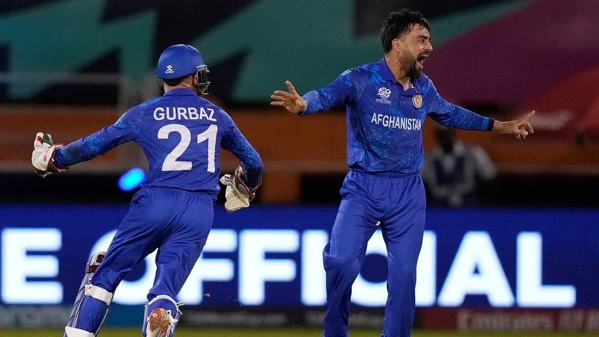 <div class="paragraphs"><p>Afghanistan's captain Rashid Khan celebrates after he bowled New Zealands Mark Chapman during an ICC Mens T20 World Cup cricket match at Guyana National Stadium in Providence, Guyana, Friday, 7 June, 2024.</p></div>