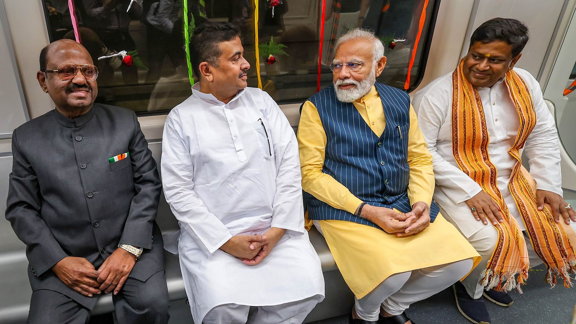 <div class="paragraphs"><p>Prime Minister Narendra Modi with West Bengal Governor CV Ananda Bose, BJP leaders Suvendu Adhikari and Sukanta Majumdar ride a metro train in Kolkata in March 2024.</p></div>