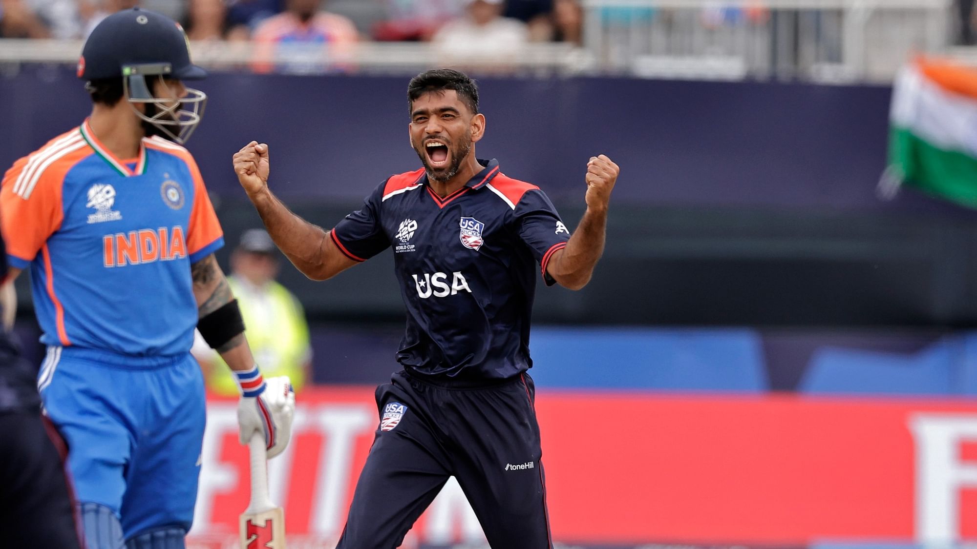 <div class="paragraphs"><p>United States' Saurabh Nethralvakar, right, celebrates the dismissal of India's Virat Kohli, center, during the ICC Mens T20 World Cup cricket match between United States and India at the Nassau County International Cricket Stadium in Westbury, New York, Wednesday, 12 June, 2024.</p></div>