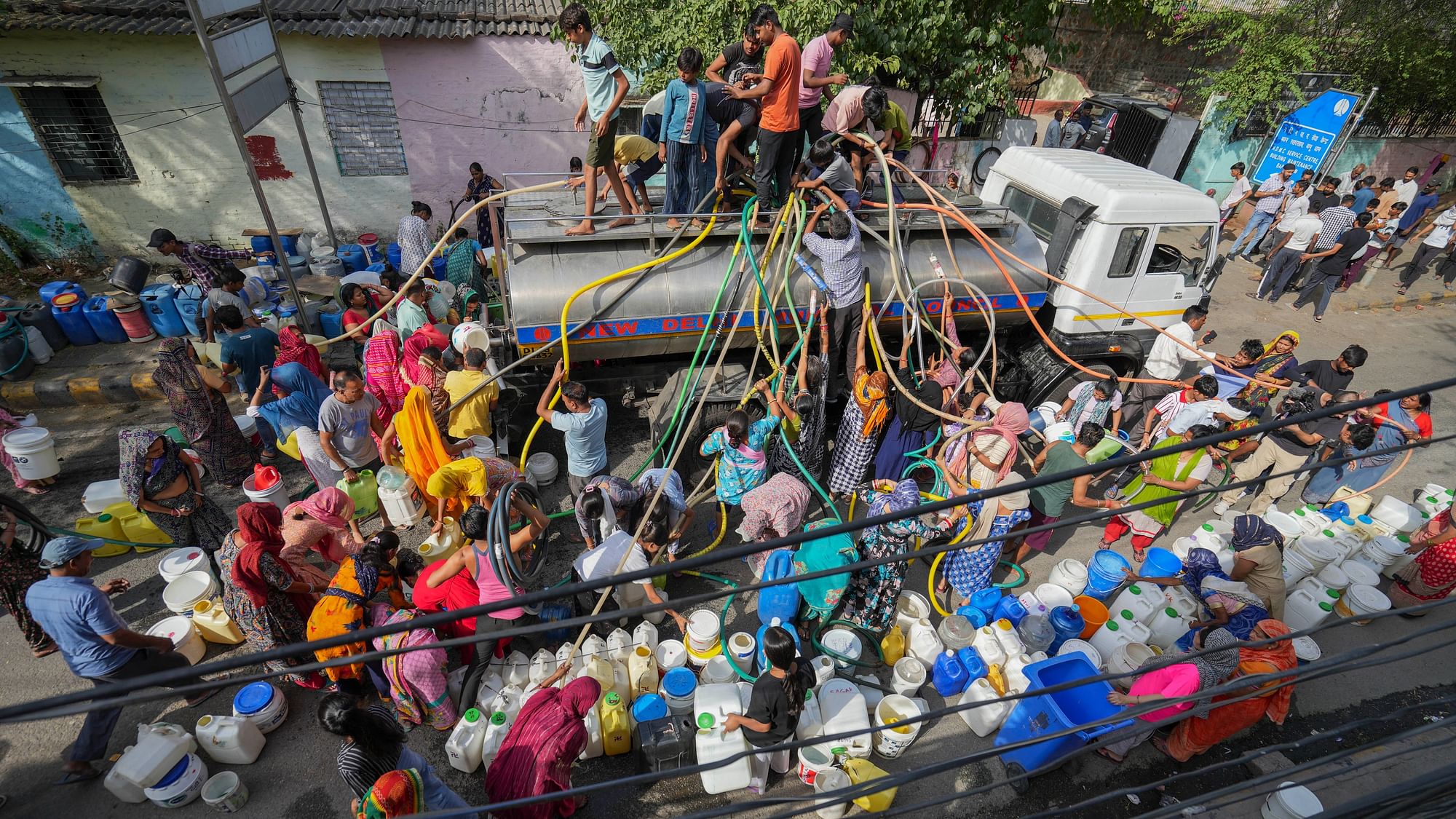 <div class="paragraphs"><p>New Delhi: People collect drinking water from a tanker amid the ongoing Delhi water crisis, at Vivekanand camp in New Delhi, Thursday, June 13, 2024.</p></div>