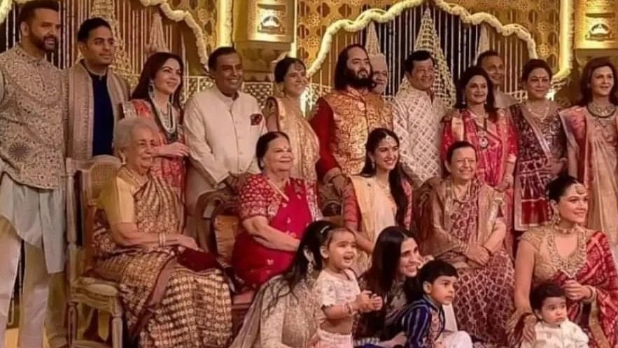 <div class="paragraphs"><p>The Ambani family and the Merchant family pose together.</p></div>