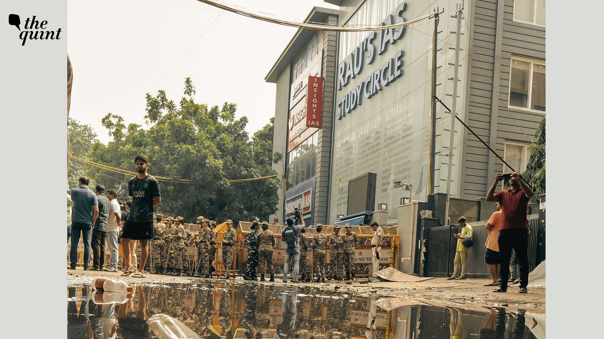 <div class="paragraphs"><p>Security personnel stand guard near a UPSC exam coaching centre after three civil services aspirants died when the basement of the coaching centre was flooded by rainwater, in New Delhi, Sunday, July 28, 2024.</p></div>