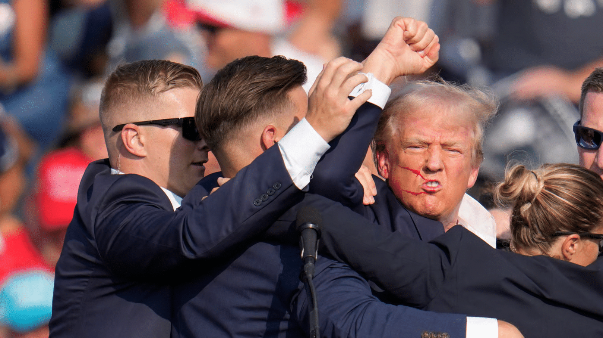 <div class="paragraphs"><p>Donald Trump surrounded by Secret Service officials after being shot at during a campaign rally in Butler, Pennsylvania.</p></div>