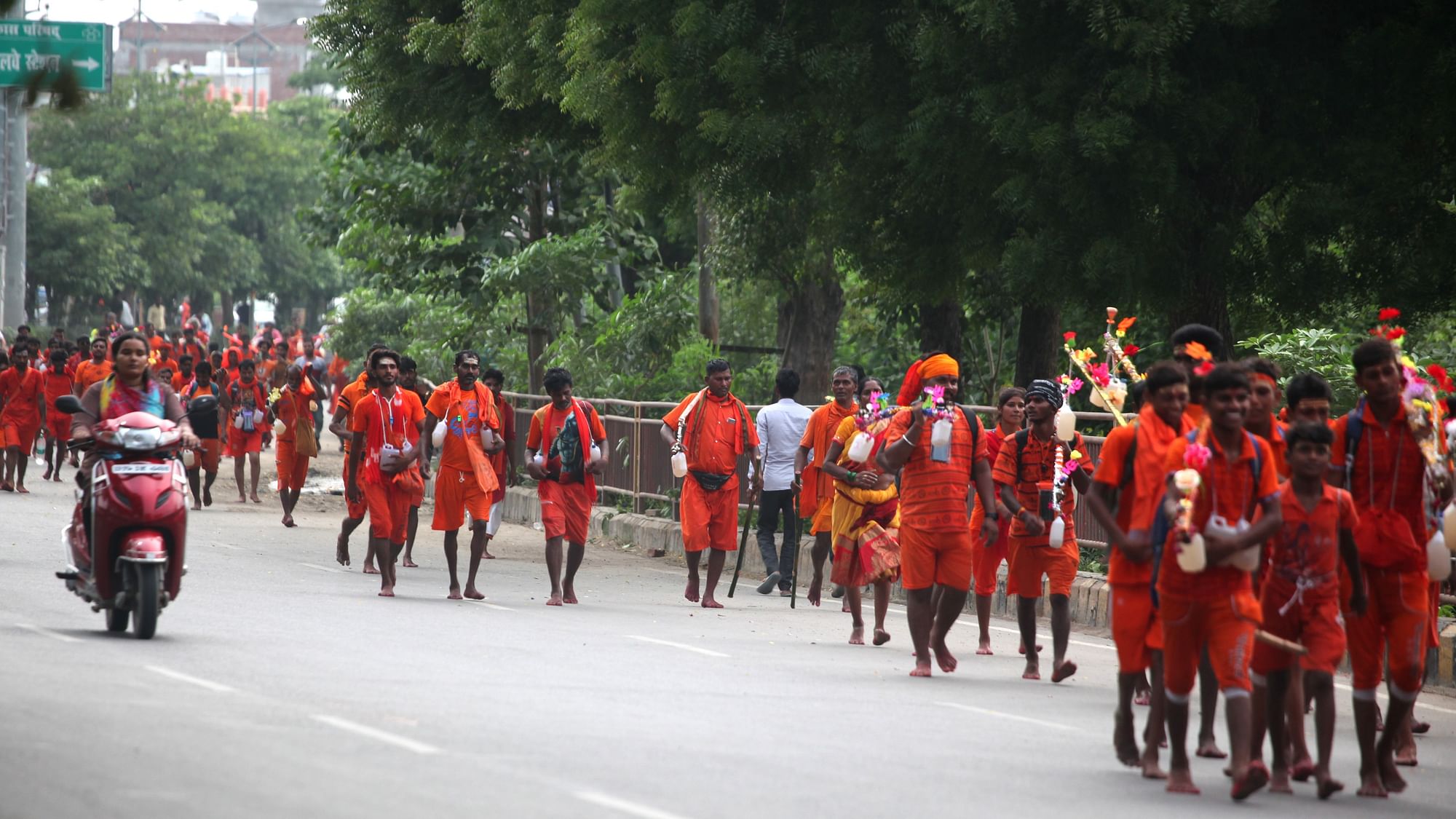 <div class="paragraphs"><p>Indian Devotees walk on road towards their destination during kanwar yatra (A religious procession ) to worship their diety Lord Shiva in the holy month of Shrawan of Hindu Calender in Prayagraj,India. During their procession they take holy water of river Ganges and offer it to Lord Shiva at the end of the procession.</p></div>