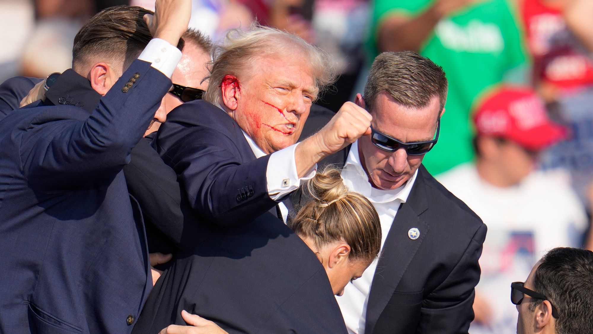 <div class="paragraphs"><p>Republican presidential candidate&nbsp;former President Donald Trump is helped off the stage at a campaign event in Butler, Pa., on Saturday, 13 July  2024.</p></div>