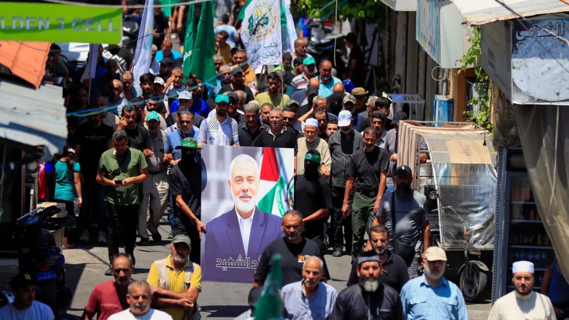 <div class="paragraphs"><p>Hamas members hold a portrait of Haniyeh during a protest to condemn his killing at al-Bass Palestinian refugee camp in the southern port city of Tyre, Lebanon.</p></div>