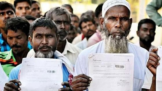 <div class="paragraphs"><p>Muslim men display their National Register of Citizens forms. Image used for representation only.</p></div>