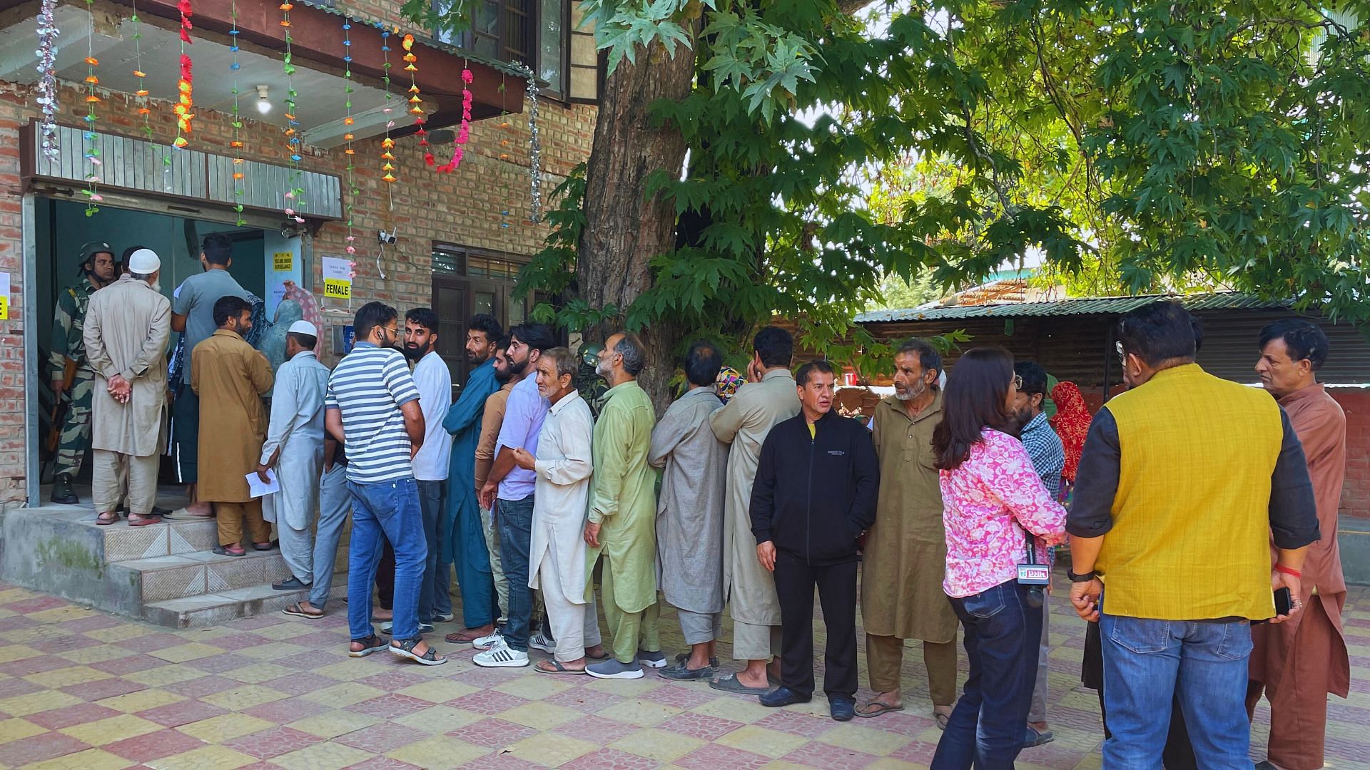 <div class="paragraphs"><p>Voters queue outside a polling booth in Pulwama.</p></div>