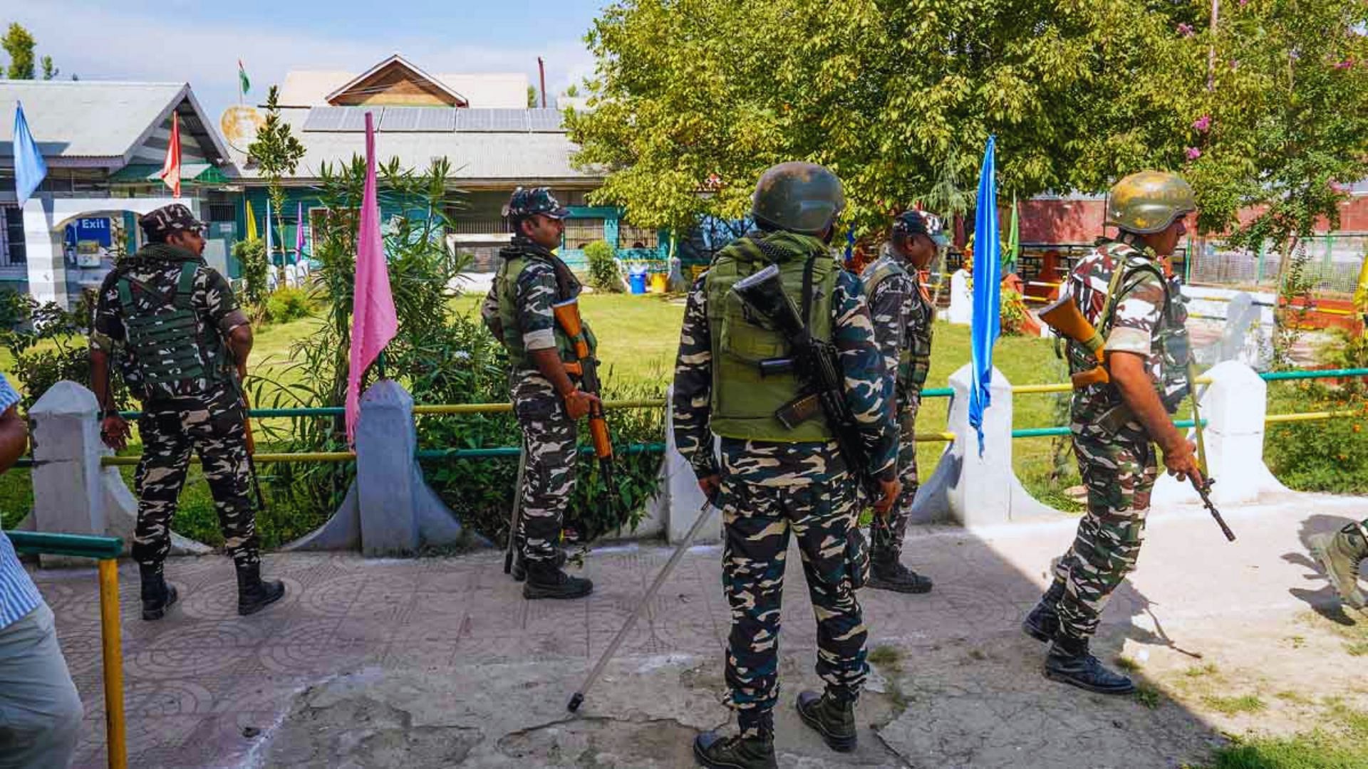 <div class="paragraphs"><p>Security personnel stand guard at a polling station ahead of the 1st phase of Jammu and Kashmir Assembly elections, at Pampore area in Pulwama district.</p></div>