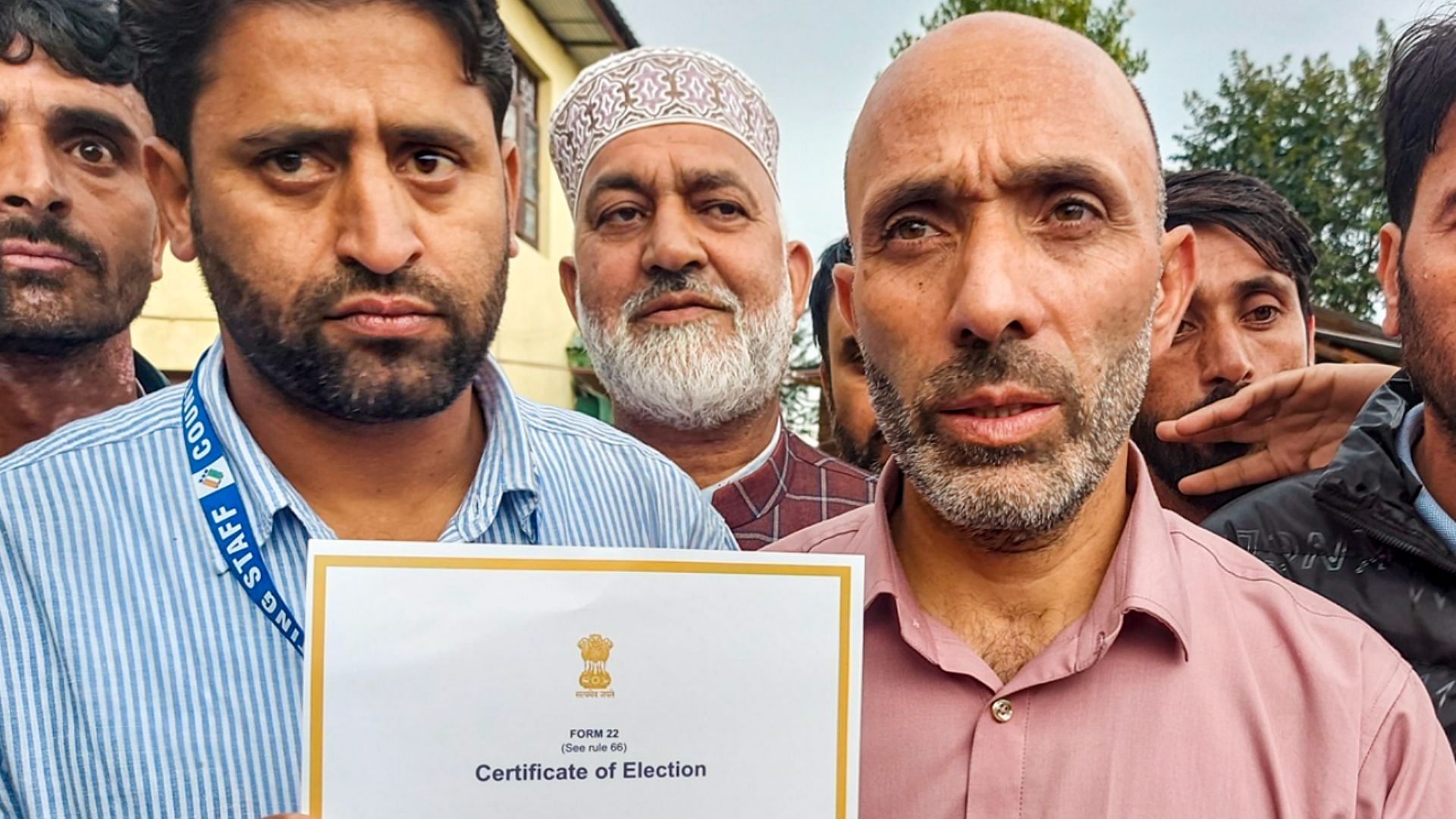 <div class="paragraphs"><p>Khurshid Ahmad Sheikh, Awami Ittehad Party candidate and brother of AIP chief Sheikh Abdul Rashid, shows the 'certificate of election' after his victory from Langate seat in the Jammu and Kashmir on Tuesday.</p></div>