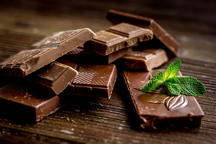 Choosing dark chocolate over nutritionally hollow cookies or toffees for a snack will satiate you much more effectively.