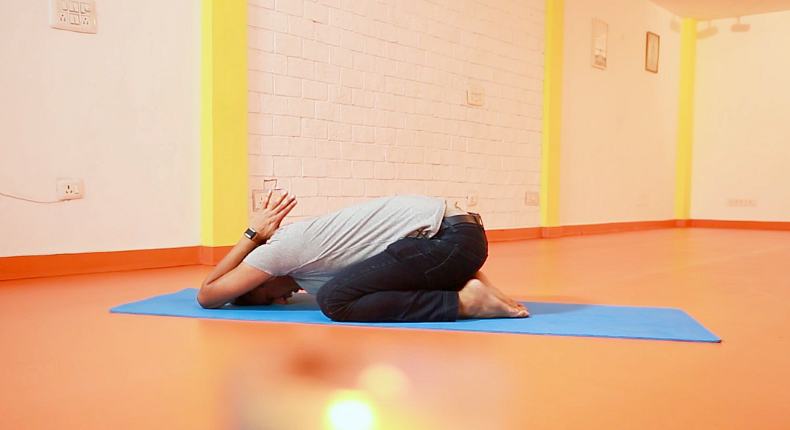 A child’s pose can be really comforting when nursing a hangover.