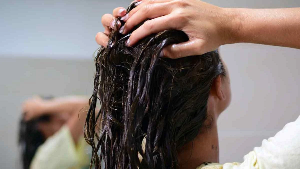 Massage the scalp with warm coconut oil.