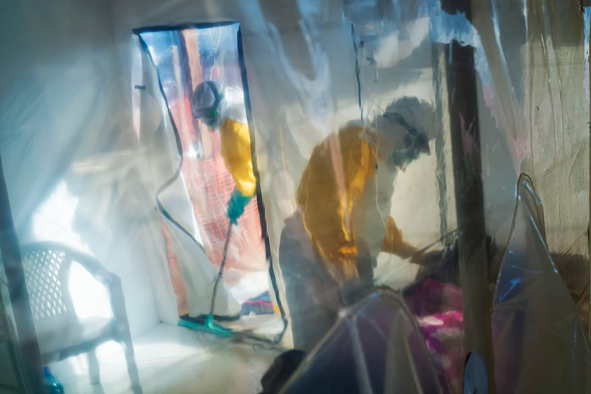 In this photograph taken Saturday 13 July 2019, health workers wearing protective suits tend to to an Ebola victim kept in an isolation cube in Beni, Congo DRC. The Congolese health ministry is confirming the country’s first Ebola case in the provincial capital of 2 million, Goma, some 360 kms ( 225 miles) south of Beni. More than 1,600 people in eastern Congo have died as the virus has spread in areas too dangerous for health teams to access.