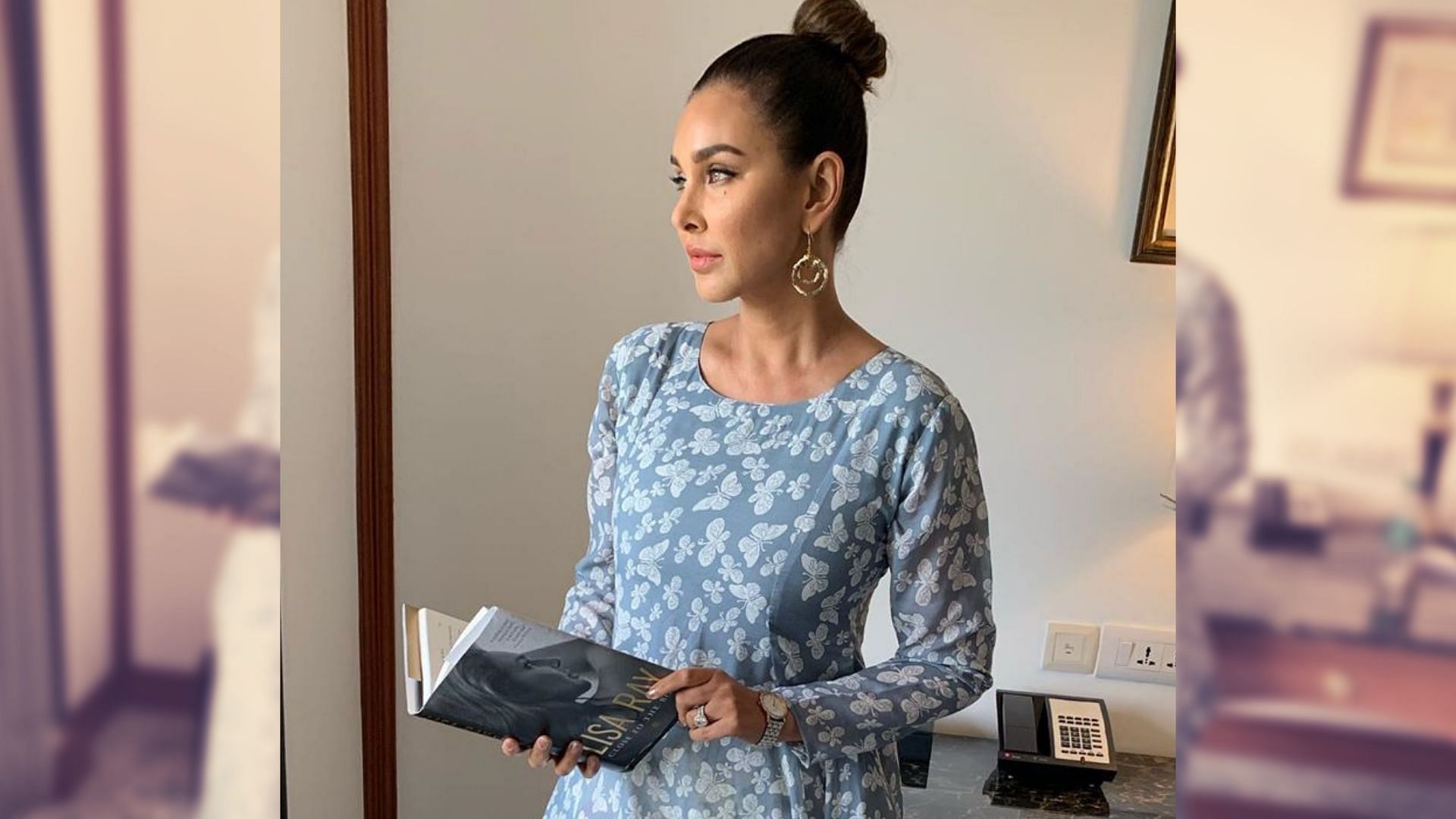 Lisa Ray poses with a copy of her book <i>Close to the Bone</i>.