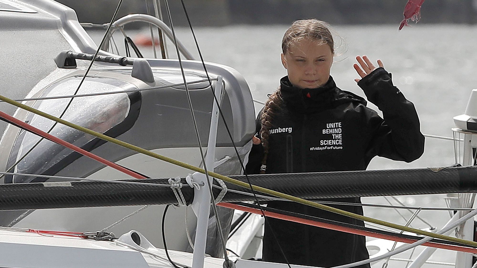In this 14 August, 2019 file photo, Climate change activist Greta Thunberg waves from the Malizia II boat in Plymouth, England.