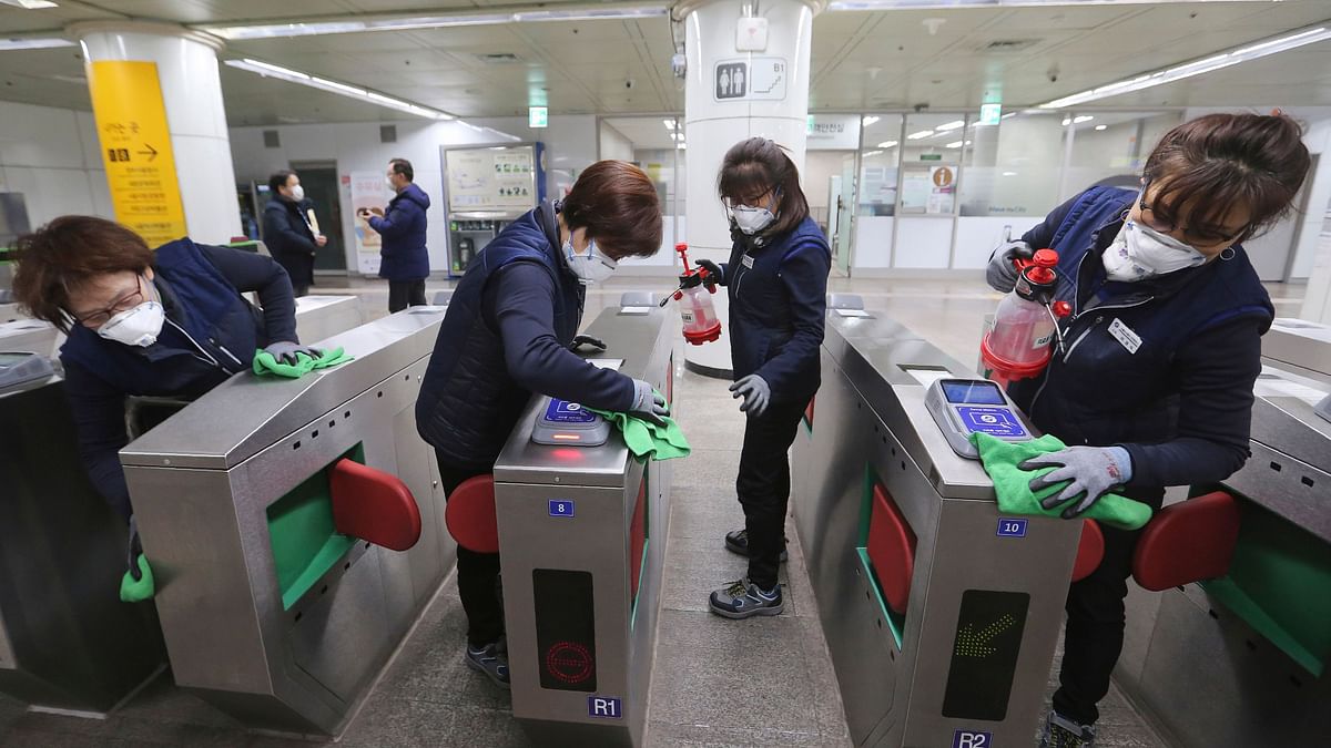 Employees disinfect ticket gates to prevent the spread of the coronavirus at a subway station in Seoul, South Korea, Jan. 28, 2020