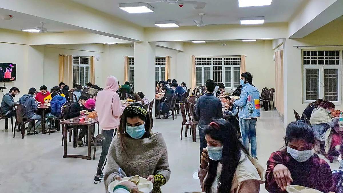 Indian nationals, who were airlifted from coronavirus-hit Wuhan city of Chinas Hubei province, have meal inside a quarantine facility set by up ITBP, in New Delhi