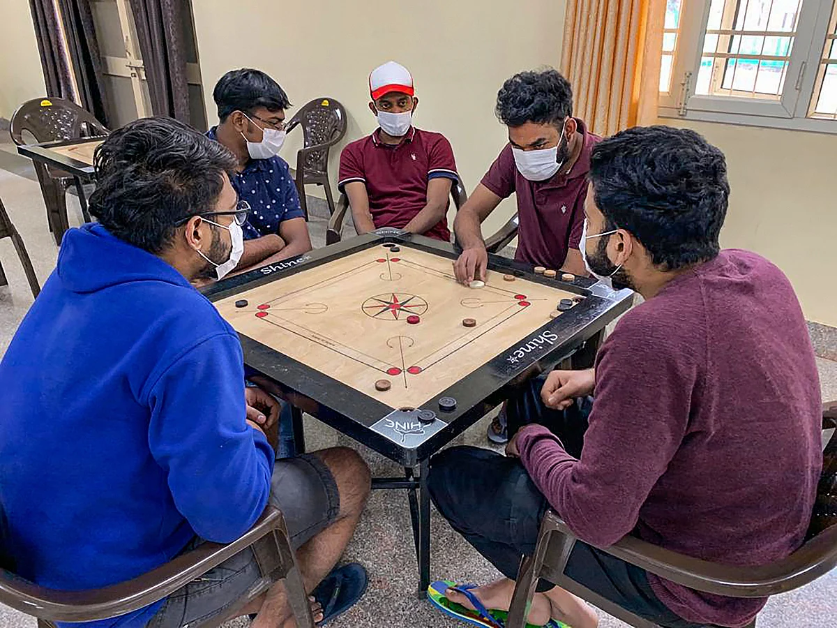 In this handout photo provided by Indo-Tibetan Border Police (ITBP), Indian nationals who were airlifted from coronavirus-hit Hubei province of Chinas Wuhan, play carrom inside a quarantine facility set by up ITBP, at Chhawla area of New Delhi, Sunday, Feb. 9, 2020. As many as 647 Indians have been evacuated through two special Air India flights amid reports of more than 900 people being killed due to the virus in China