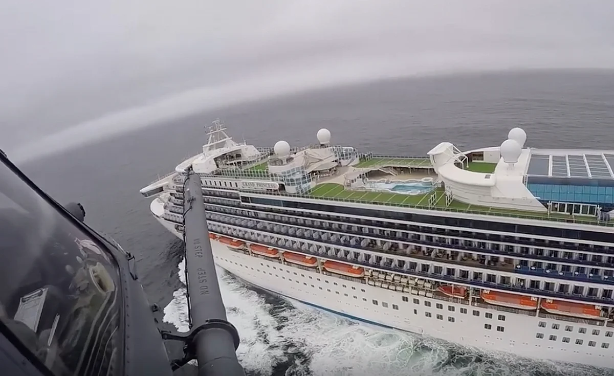 qUAA helicopter carrying airmen with the 129th Rescue Wing flies over the Grand Princess cruise ship off the coast of California Thursday, March 5, 2020.