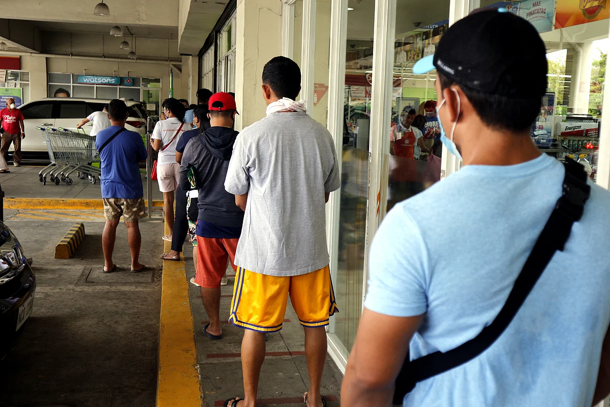 Customers line up with distance outside a store for social distancing on the COVID-19 virus outbreak.