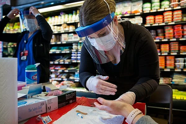 To find out what percentage of people have anti-coronavirus antibodies in their blood, health departments are starting to sample the public, as at this grocery store in New York.