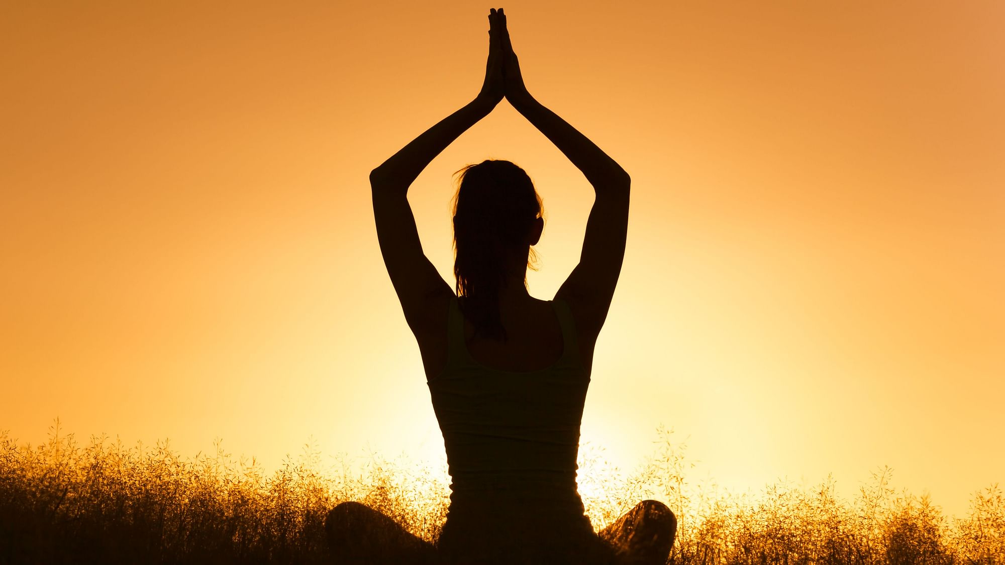 Fit woman doing yoga stretching exercise outdoor in beautiful mountains  landscape. Female on the rock with sea and sunrise or sunset background  training asans. Silhouette of woman in yoga poses 7566878 Stock