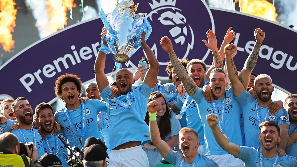  Manchester City players celebrate winning the Premier League title after beating Brighton 4-1 at the Amex Stadium on 12 May 2019.